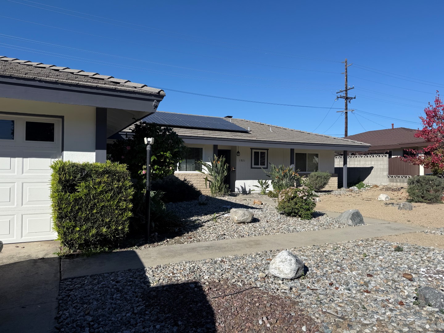 Front exterior before renovation — original facade and unfinished yard